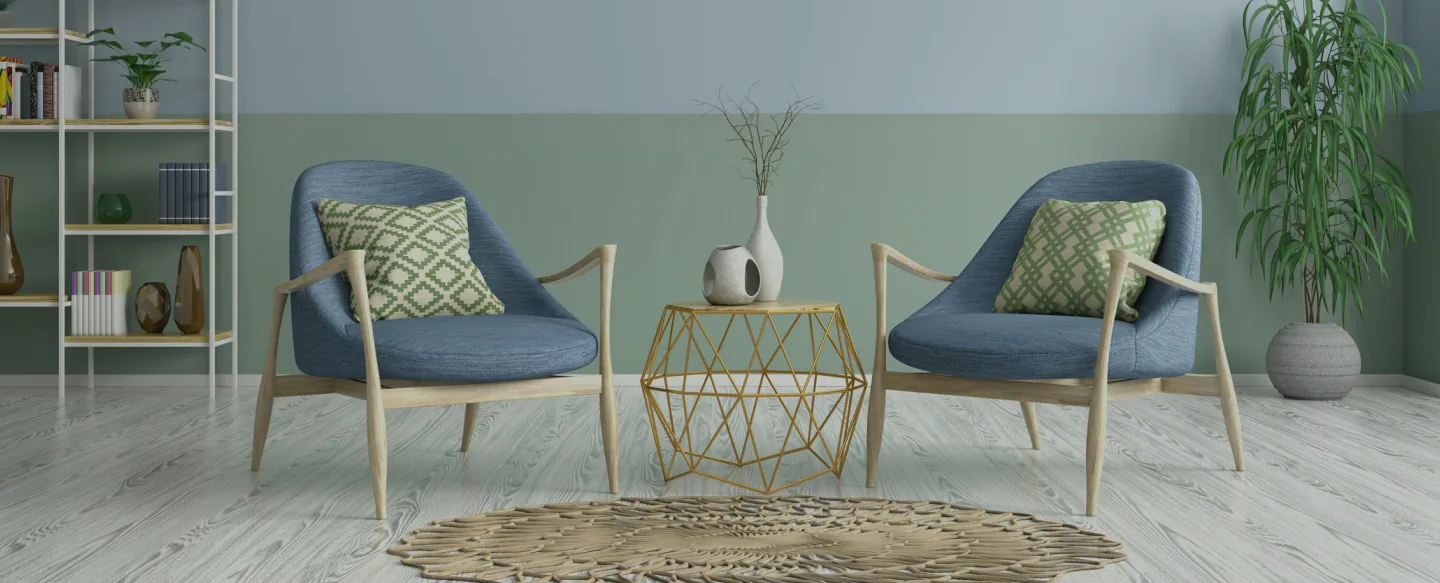 A calm therapy room with two armchairs and plants.